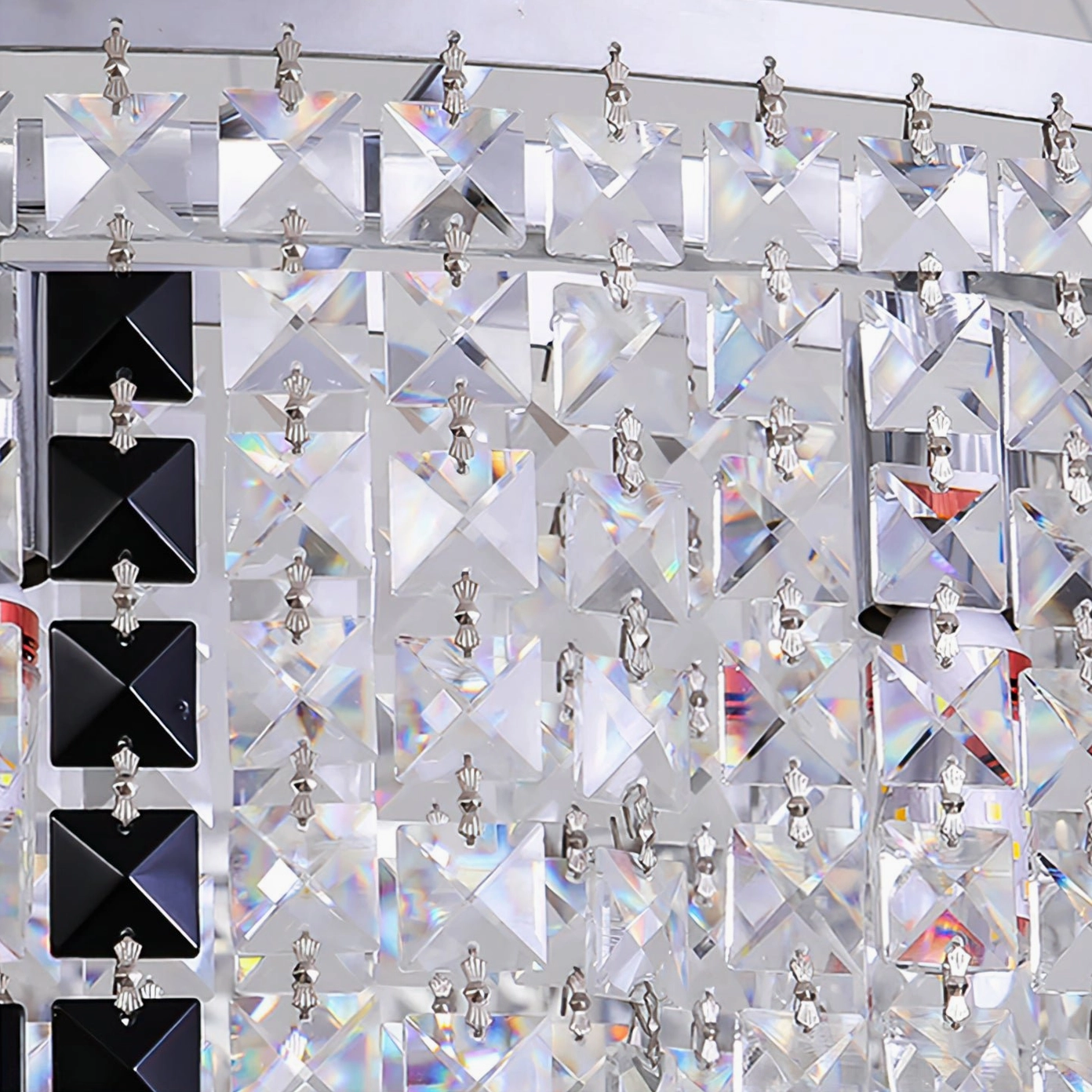 Crystal chandelier components including faceted cut glass crystals, silver mounting clips, and decorative hardware close-up