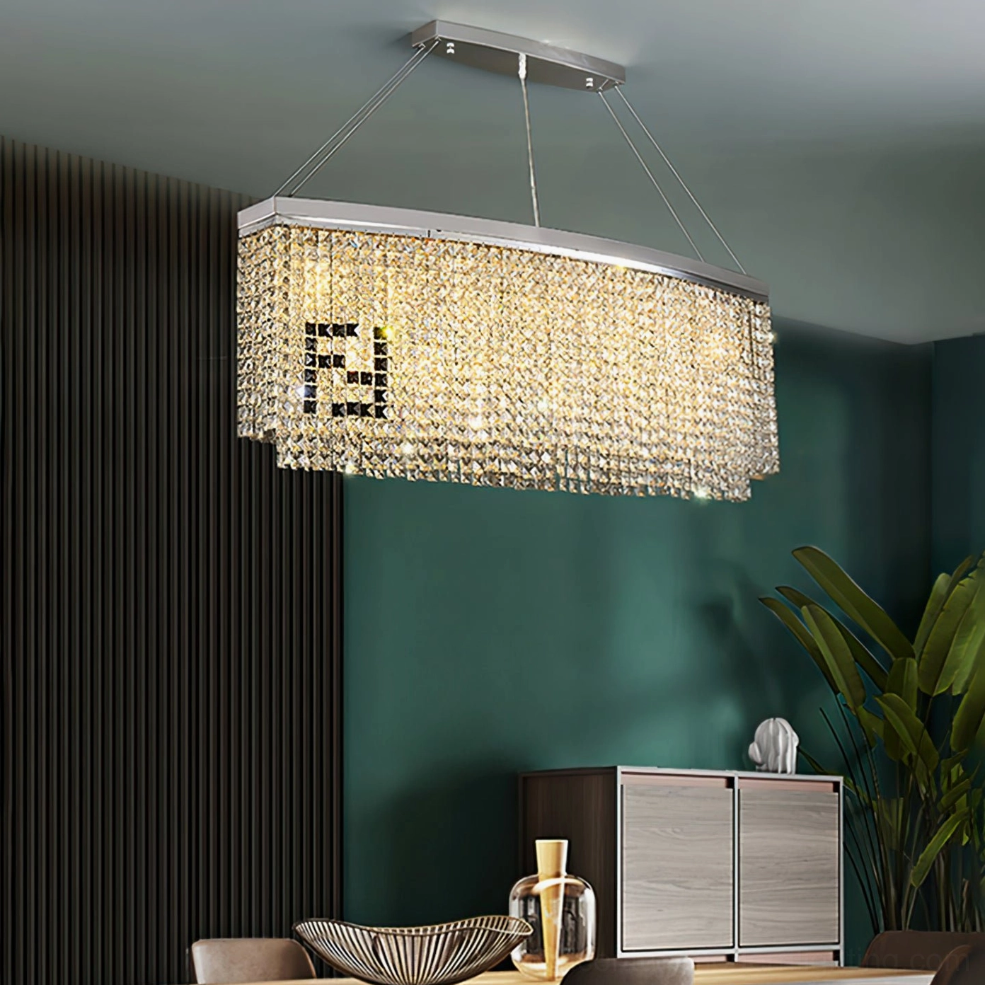 Liliana chandelier with warm glowing crystal finish in dining space with emerald accent wall
