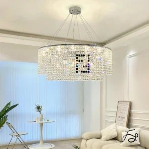 Modern round crystal chandelier suspended in French-style living room with sofa, displaying crystal light refraction and silver suspension cables