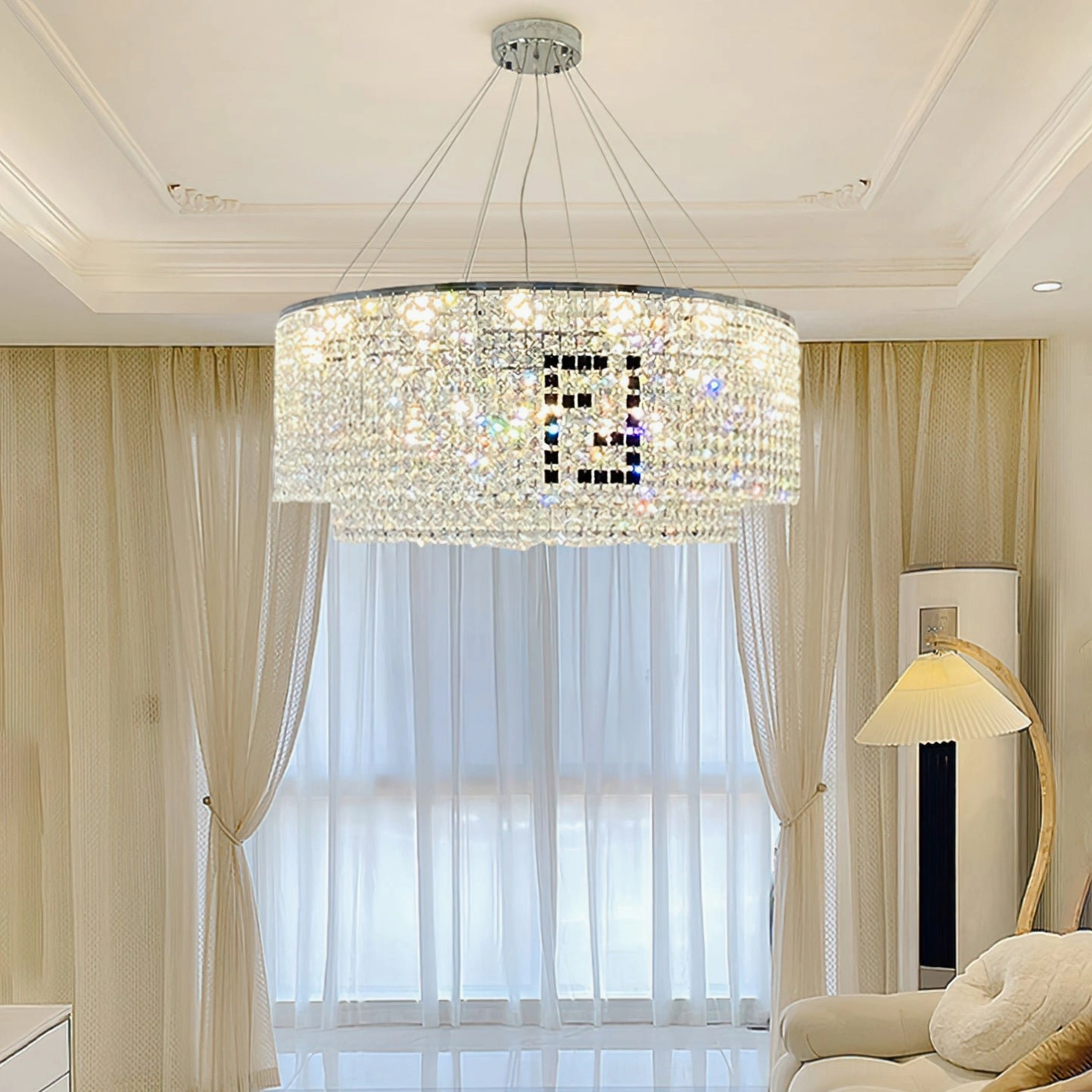 Modern crystal chandelier installed in contemporary living room with beige curtains, floor lamp, and minimalist decor