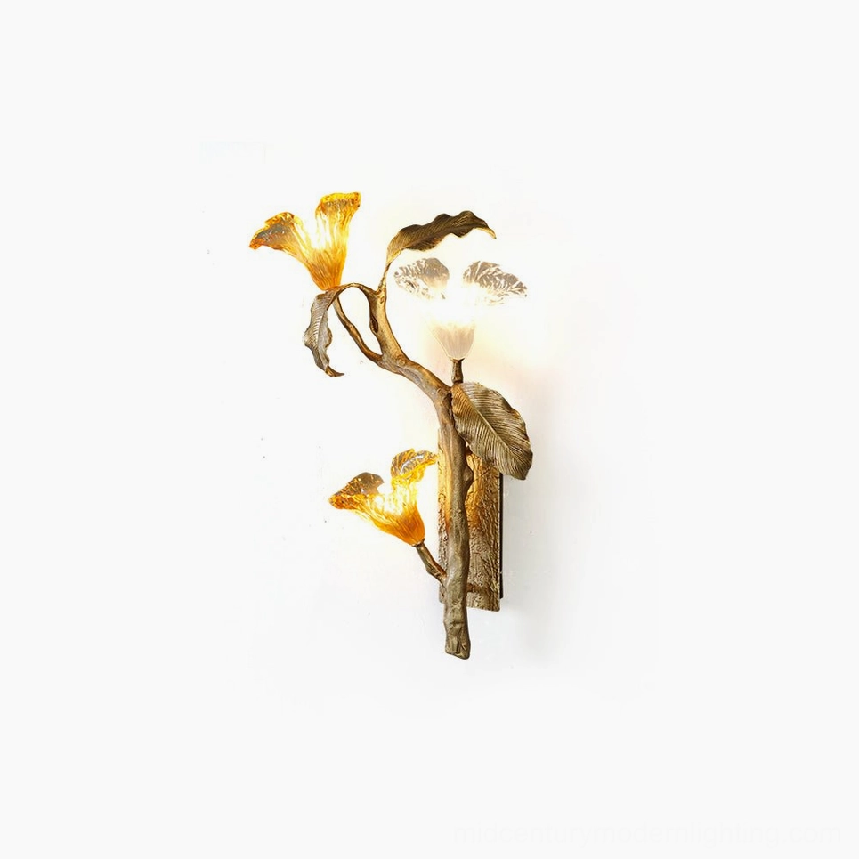 Artistic front-facing view of hand-cast brass lily branch sconce with glass blooms against white backdrop