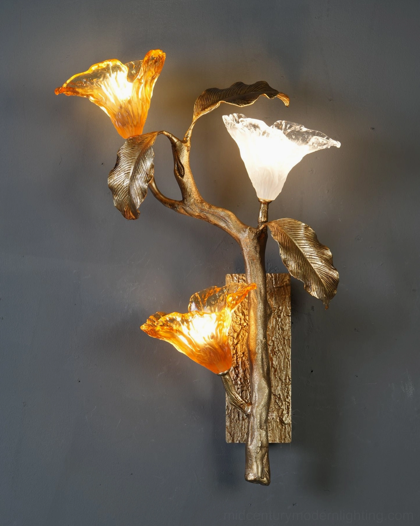 Hand-cast brass stem detail of lily branch sconce showing organic root-like textured surface