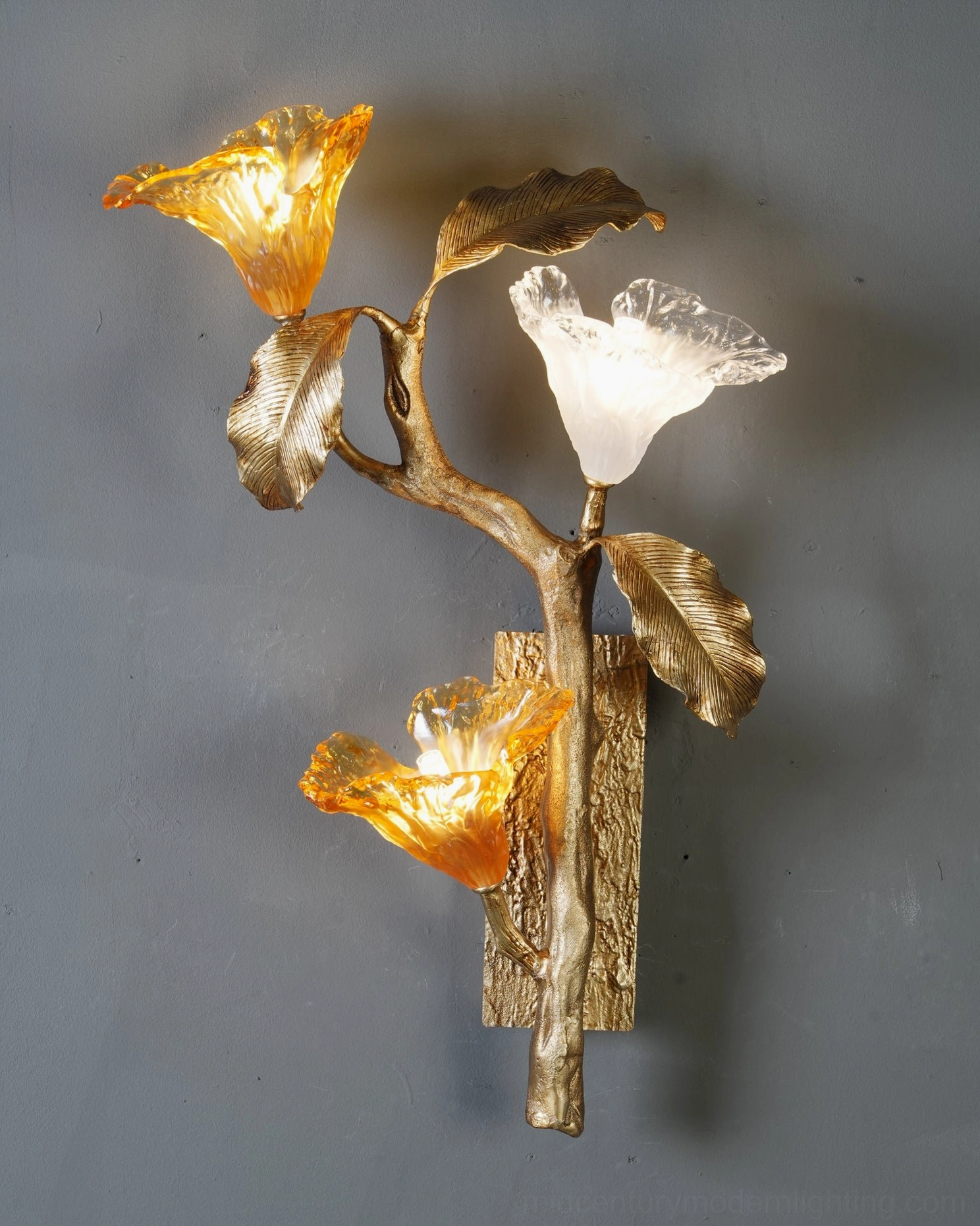 Hand-cast brass lily branch sconce detail showing textured stem and twisted botanical form