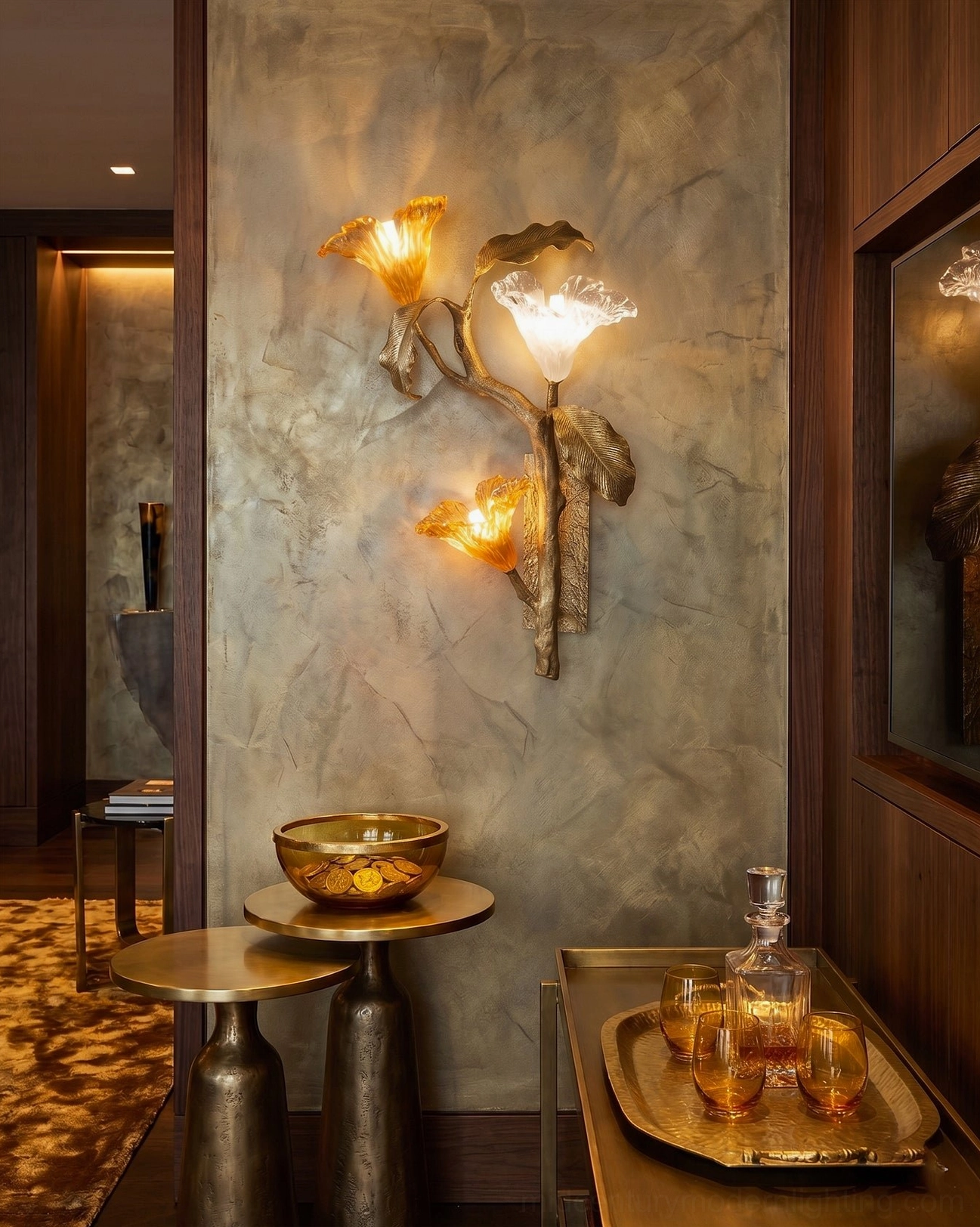 Brass botanical wall sconce installed in luxury wood-paneled entryway with marble textured walls