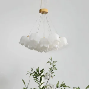 Close-up detail of lily of the valley ceiling chandelier with frosted acrylic flower shades and gold metal hardware in modern interior setting