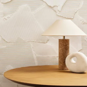Limoges table lamp three-quarter view on side table with textured wall backdrop and warm marble base detail