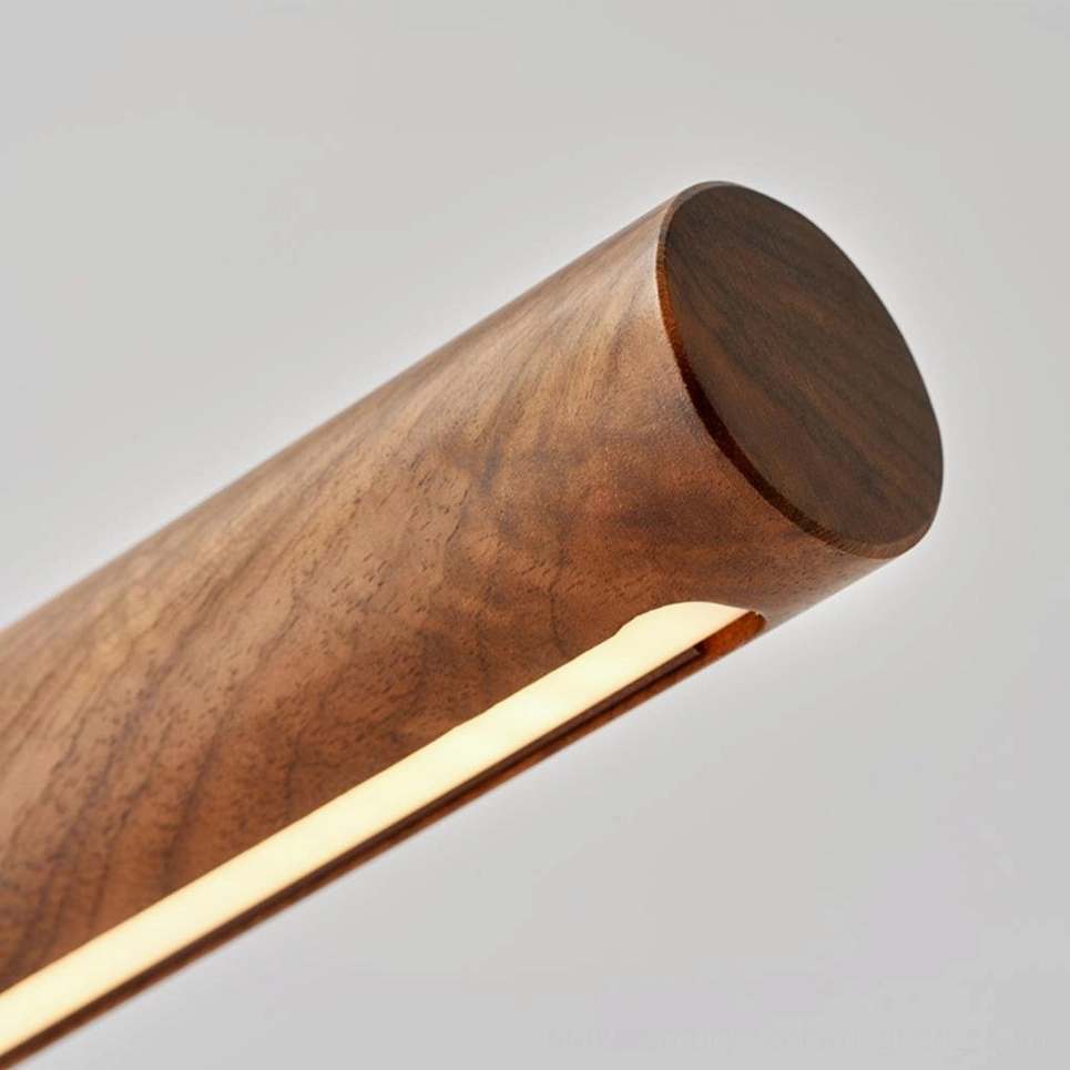Mid-century modern table lamp with adjustable arm feature, polished gold stem and wood base lifestyle shot