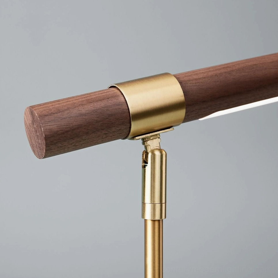 Close-up detail of linear lamp pivot joint and arm structure, brass fastener and walnut wood detail macro shot