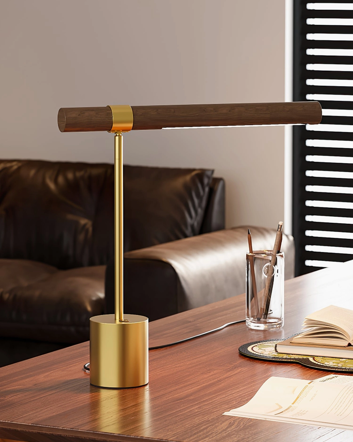 Adjustable desk lamp next to brown leather sofa in living room study, warm neutral contemporary interior design
