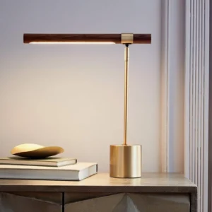LED table lamp glowing warm light in luxury home interior, polished gold and walnut on side table, evening ambiance