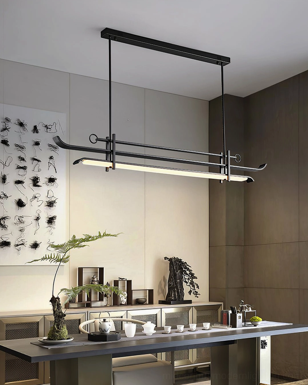 Contemporary black metal linear pendant in upscale lounge with calligraphy wall art and botanical decor