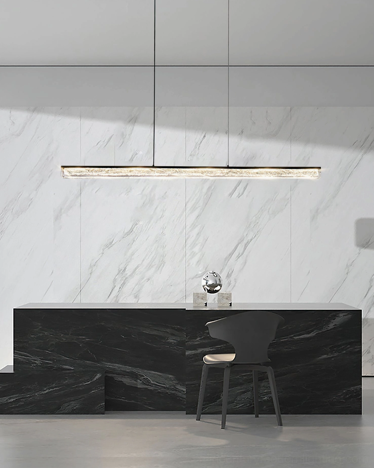 Elegant black linear pendant chandelier above luxury marble kitchen bar in contemporary home