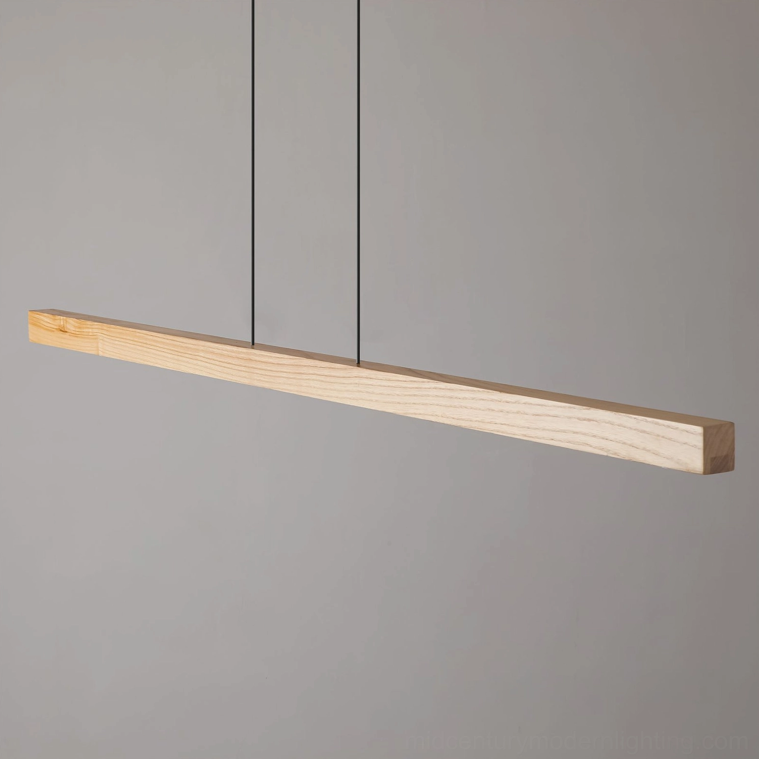 Front view of slim linear wood LED pendant with simple black hanging cords and minimalist design