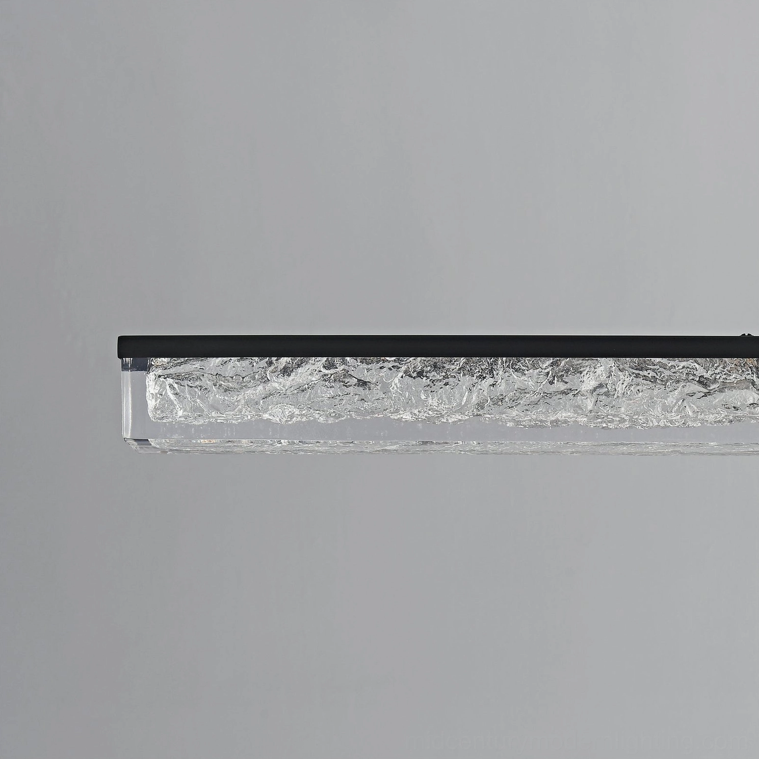 Side profile of sleek minimalist linear LED pendant chandelier with thin black metal suspension
