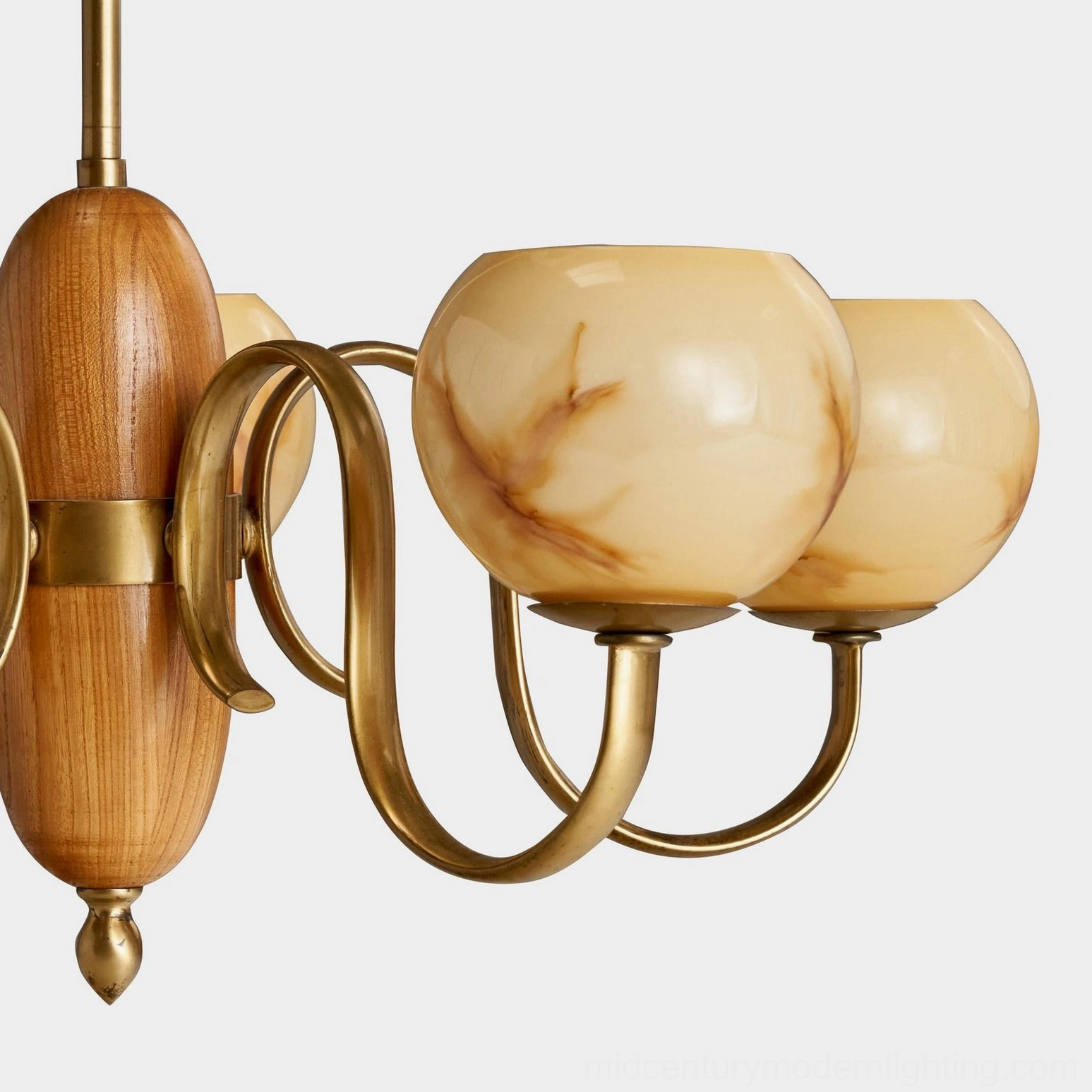 Linnea walnut and brass chandelier detail shot showing hand-blown glass shade texture and construction