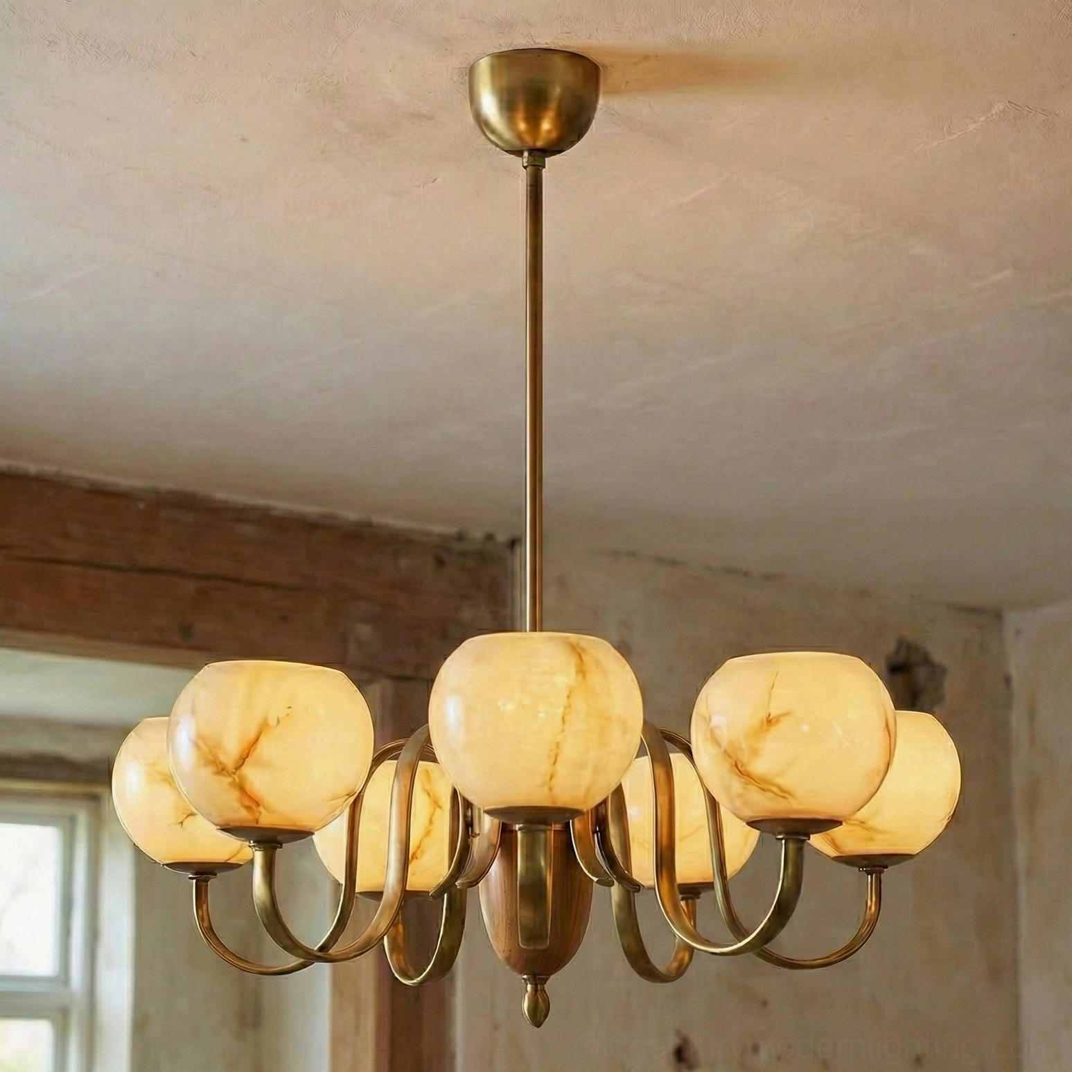 Illuminated Linnea chandelier casting soft candlelit ambiance over wooden beam interior with window light