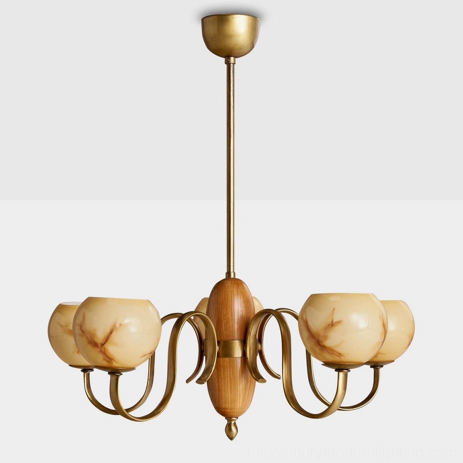 Linnea chandelier with smooth veined cream glass shades and antique brass frame in white studio background