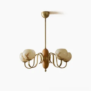 Linnea mid-century modern chandelier with walnut spindle and antique brass arms, featuring hand-blown beige glass shades in studio front view