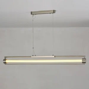 Lirna LED pendant light illuminated with warm white light against gray wall backdrop