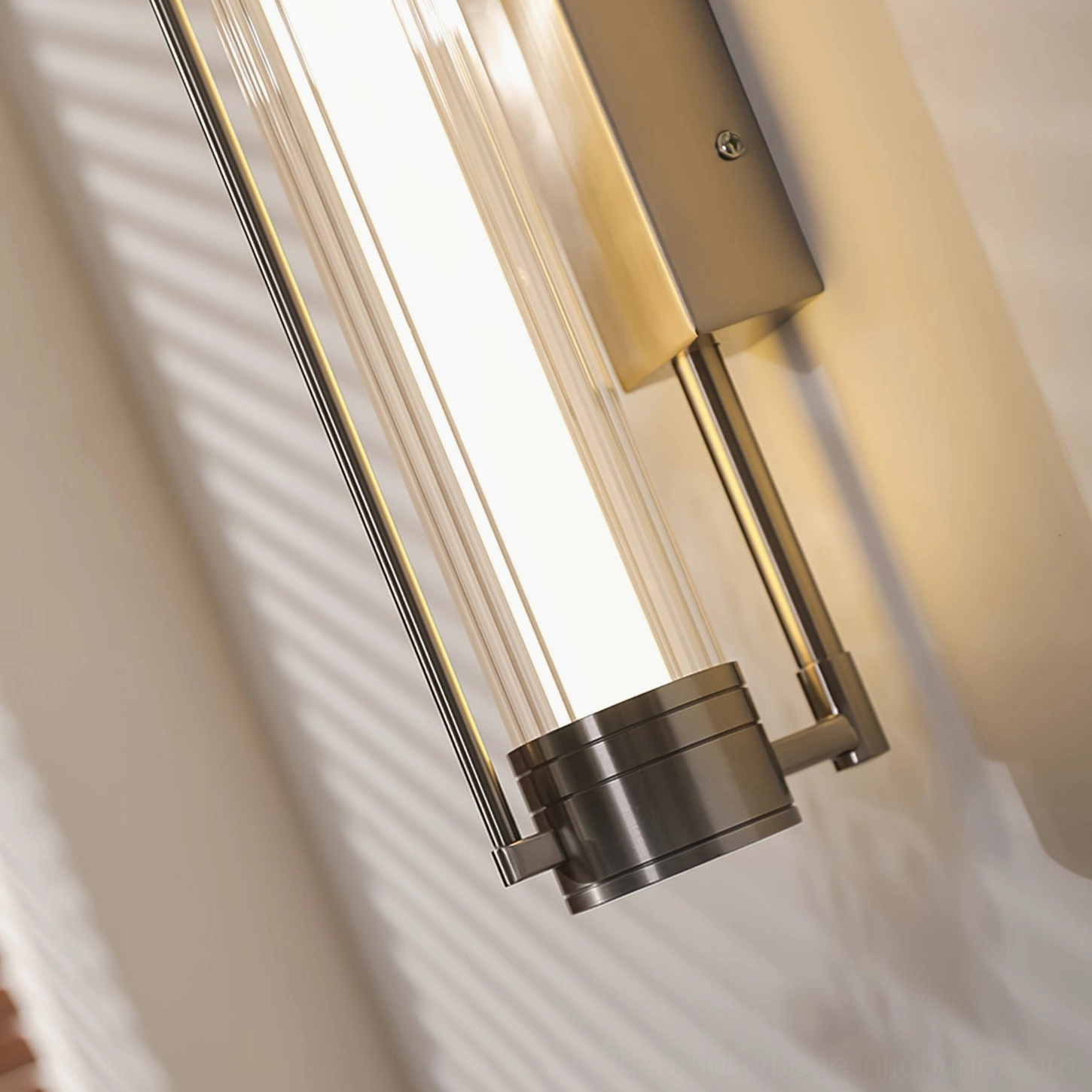 Lirna nickel wall sconce close-up ribbed glass diffuser shadow detail