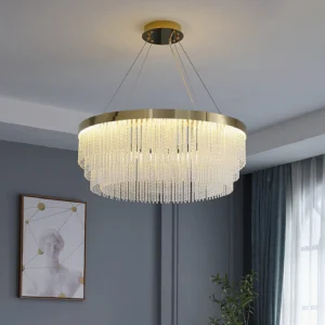 Contemporary tiered crystal chandelier with warm gold finish illuminated in modern living room setting