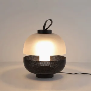 Illuminated contemporary table lamp showing warm white LED glow through frosted glass shade and metal mesh