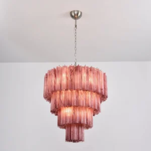 Lit dusty rose tiered glass chandelier overhead angle warm ambient lighting sculptural form