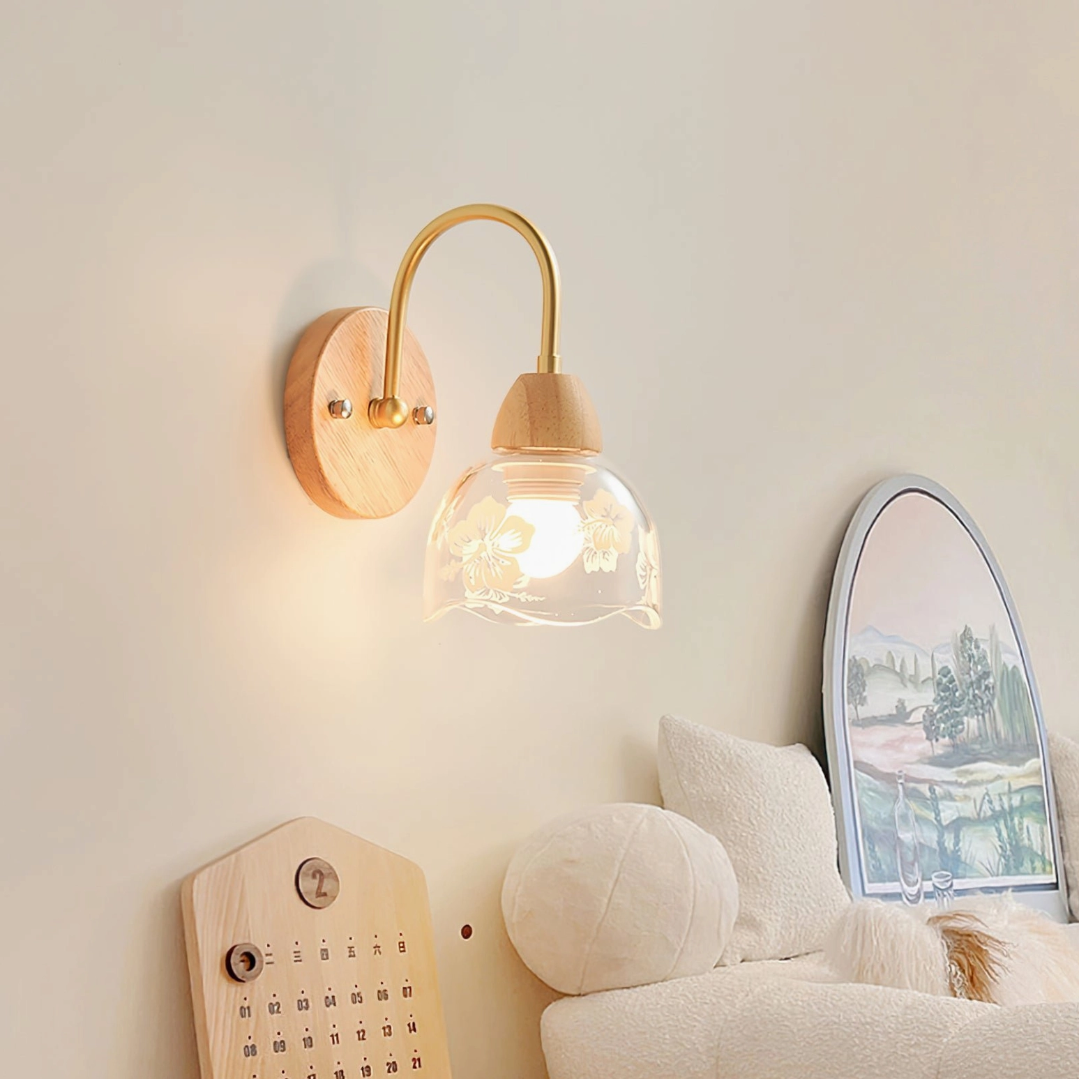 Brass arm wall sconce illuminating cozy living room with boho decor and artwork
