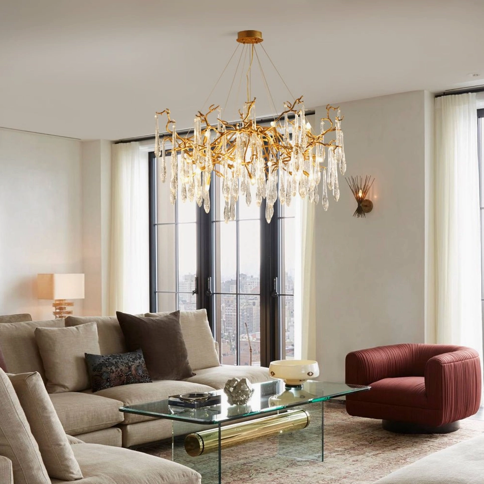 Upscale contemporary living room featuring Livio Branch Chandelier above sectional sofa in warm lighting