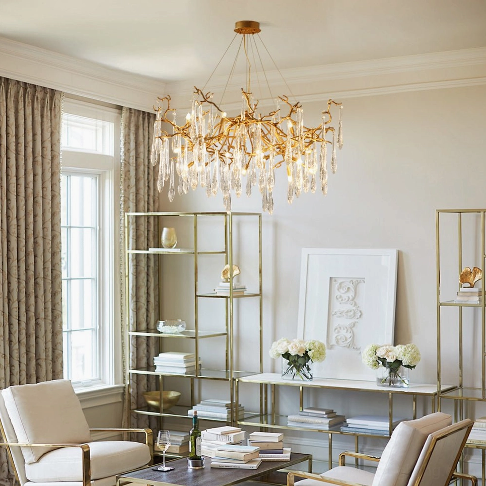 Modern living room with Livio Chandelier suspended over coffee table, minimalist shelving backdrop