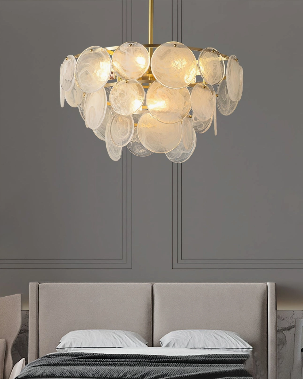 Loire Chandelier positioned above master bed in neutral bedroom with wainscot walls and upholstered headboard