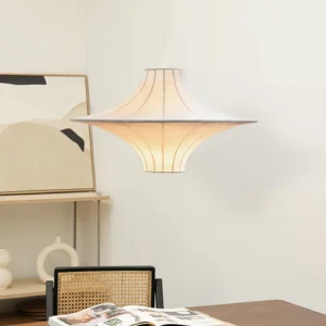 Lokki beige silk pendant lamp hanging in modern dining workspace, warm glowing fabric shade with flared silhouette