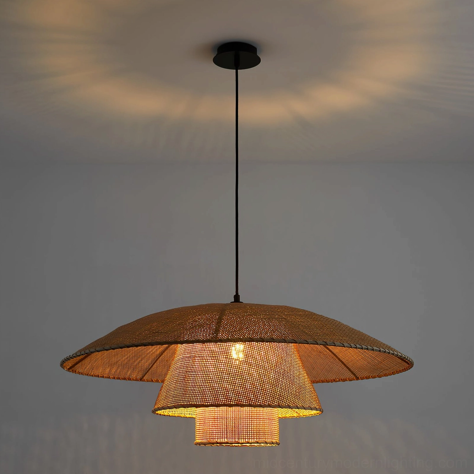 Two-tier rattan pendant lamp with warm downlighting in minimalist gray interior space