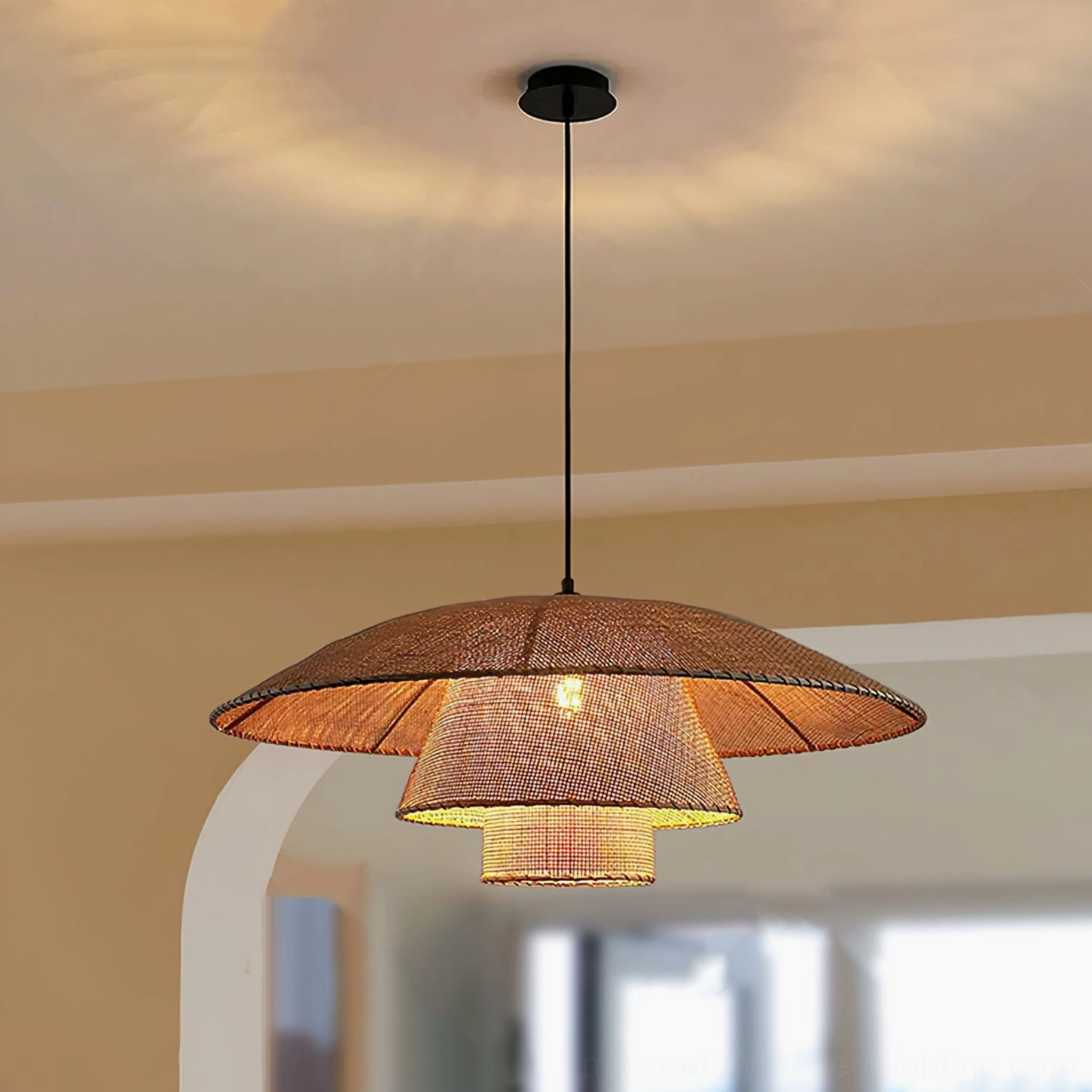Overhead view of layered rattan pendant lamp with dark brown natural finish in warm residential interior