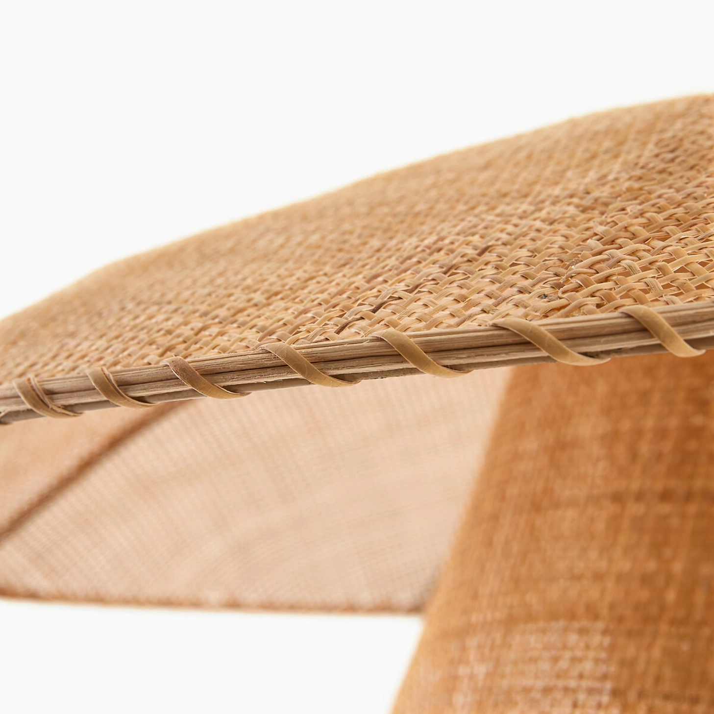 Detailed view of stitched rattan edge showing artisanal craftsmanship of Lola pendant lamp