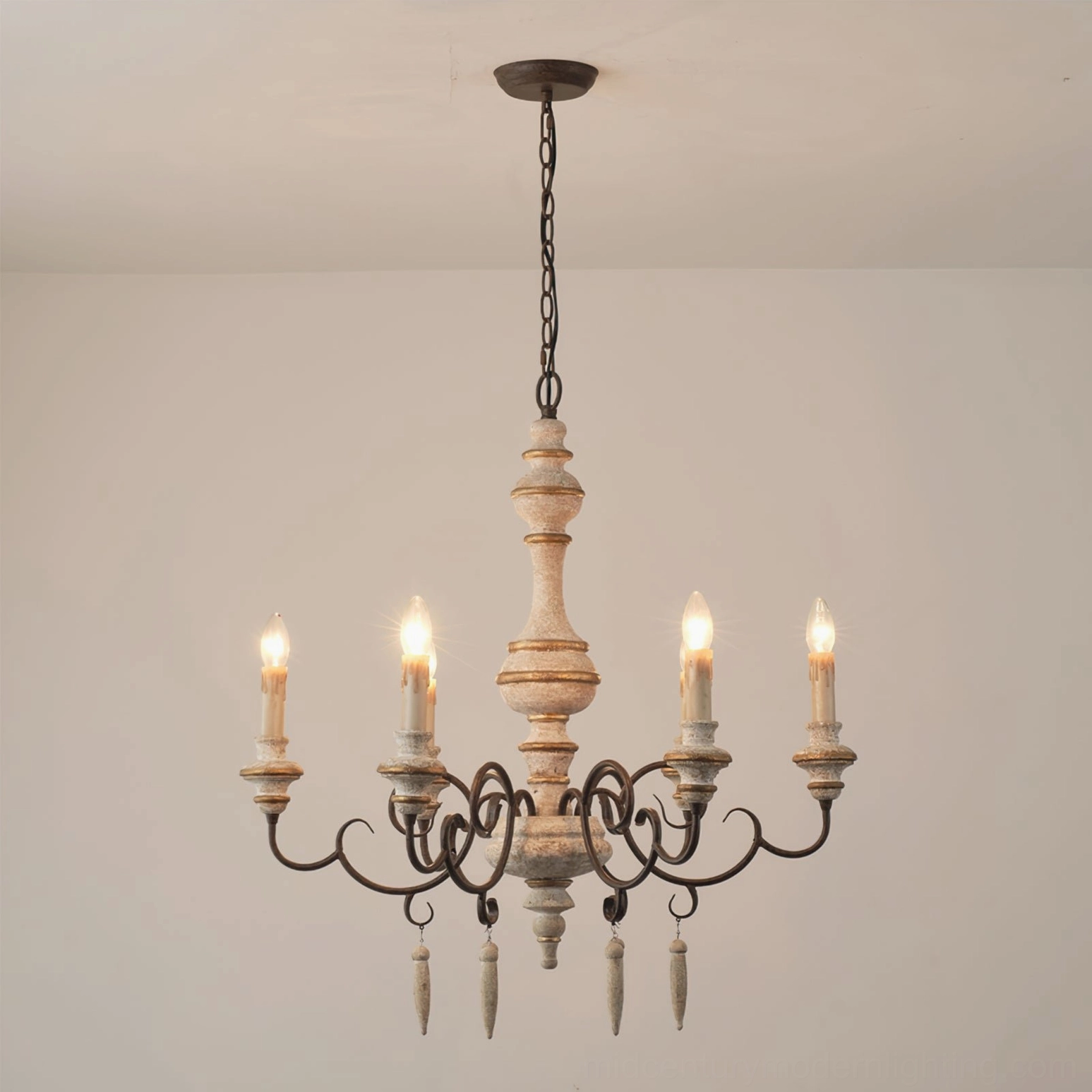Lomba 6-head chandelier hanging in white room showing full illumination and hand-turned wooden center pole