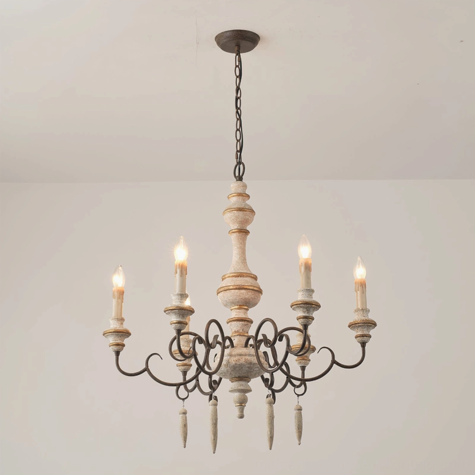 Lomba chandelier illuminated in minimalist interior room showing warm candlelight ambiance from six light sources