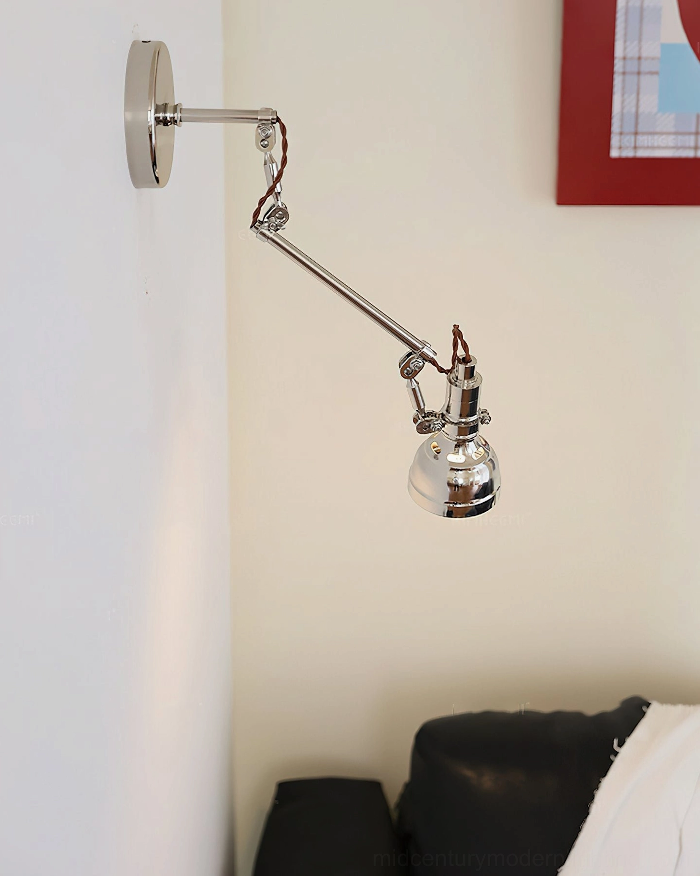 Extended swing arm wall lamp in living room corner, polished silver adjustable jointed design