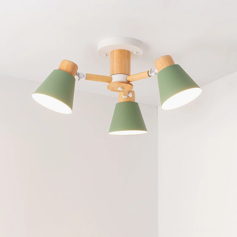 3-head Loona ceiling lamp with green matte shades and natural wood in cozy bedroom with warm ambient light