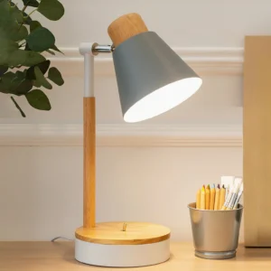 Grey matte Loona lamp on home office desk with metal pen holder and natural wooden pole - side view