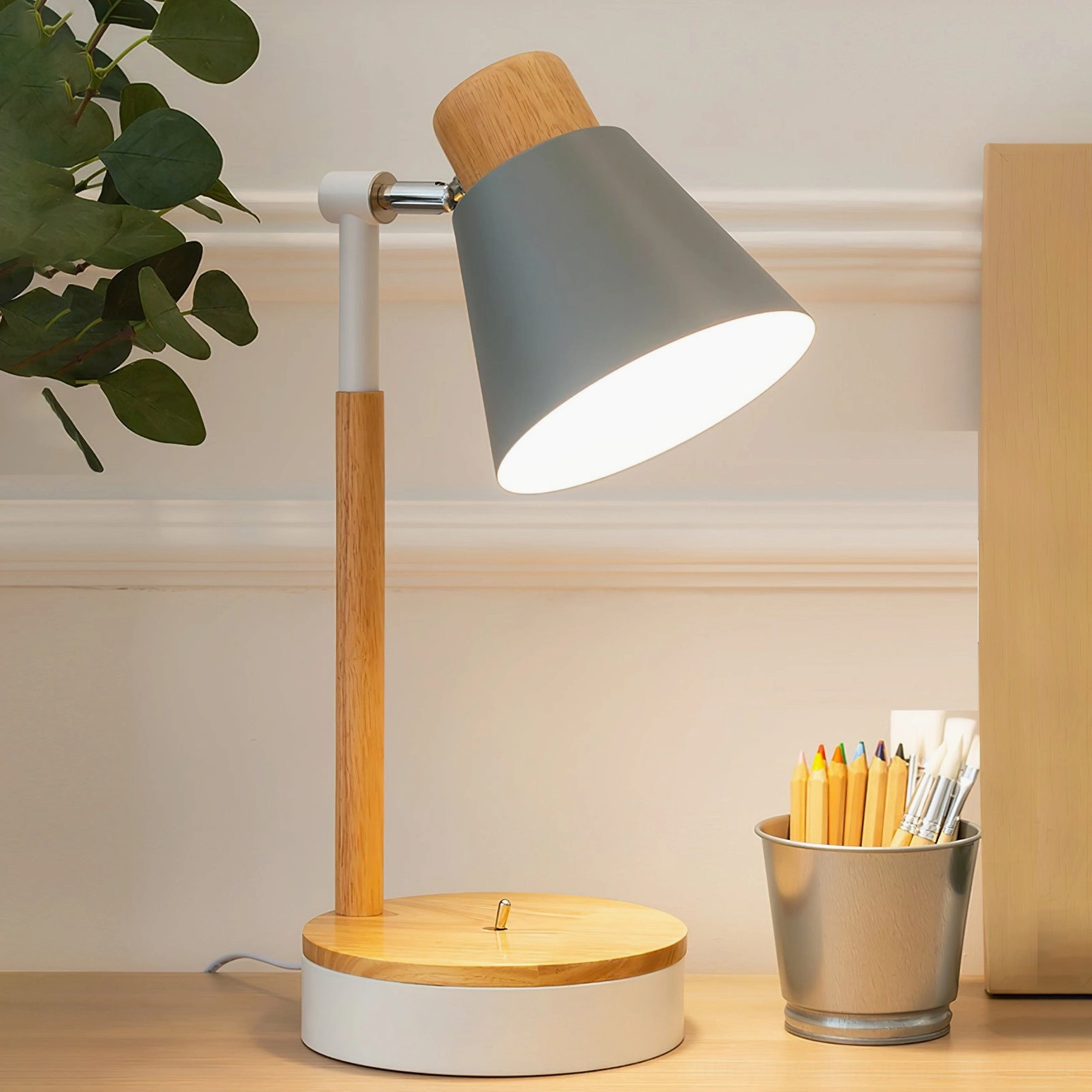 Grey matte Loona lamp on home office desk with metal pen holder and natural wooden pole - side view