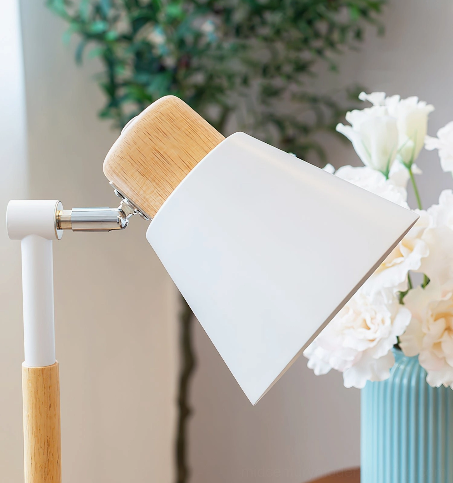 White Loona table lamp with white metal arm on floral decorated desktop with blue vase - styled interior
