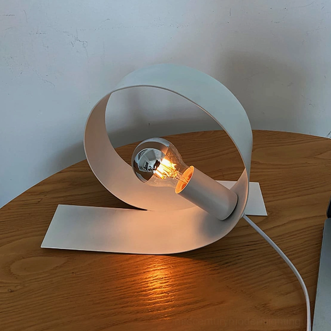 Looping table lamp studio detail showing matte white finish and curved form