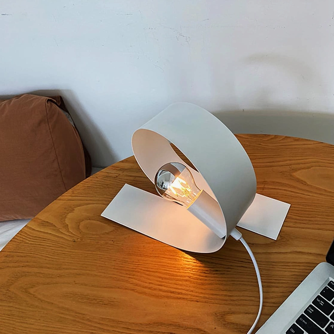Looping sculptural table lamp minimalist design aesthetic