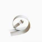 Looping white metal table lamp with exposed bulb, front side view on studio background