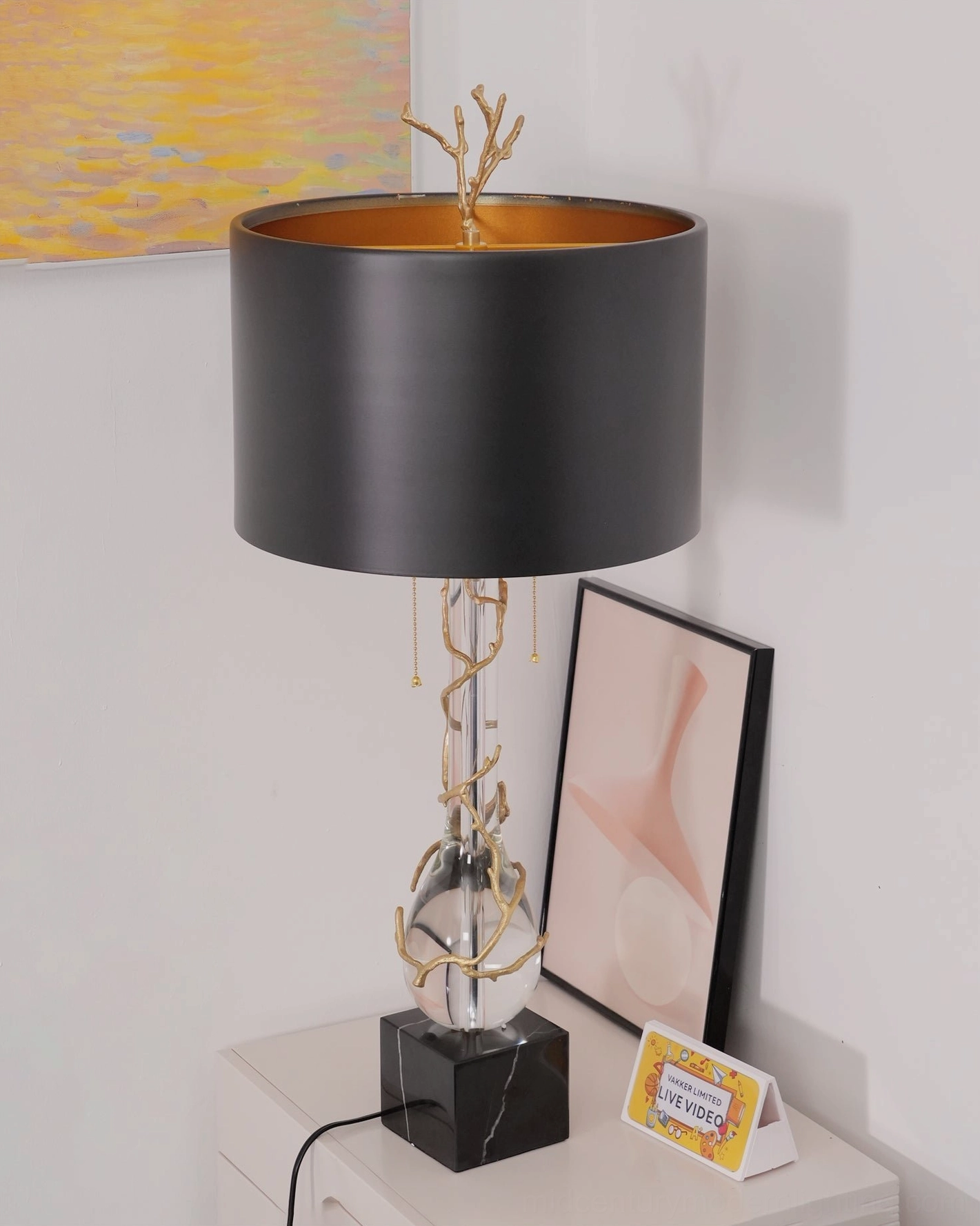 Lora bedside lamp close-up of clear crystal pillar with gold branch finial detailing and sculptural elements