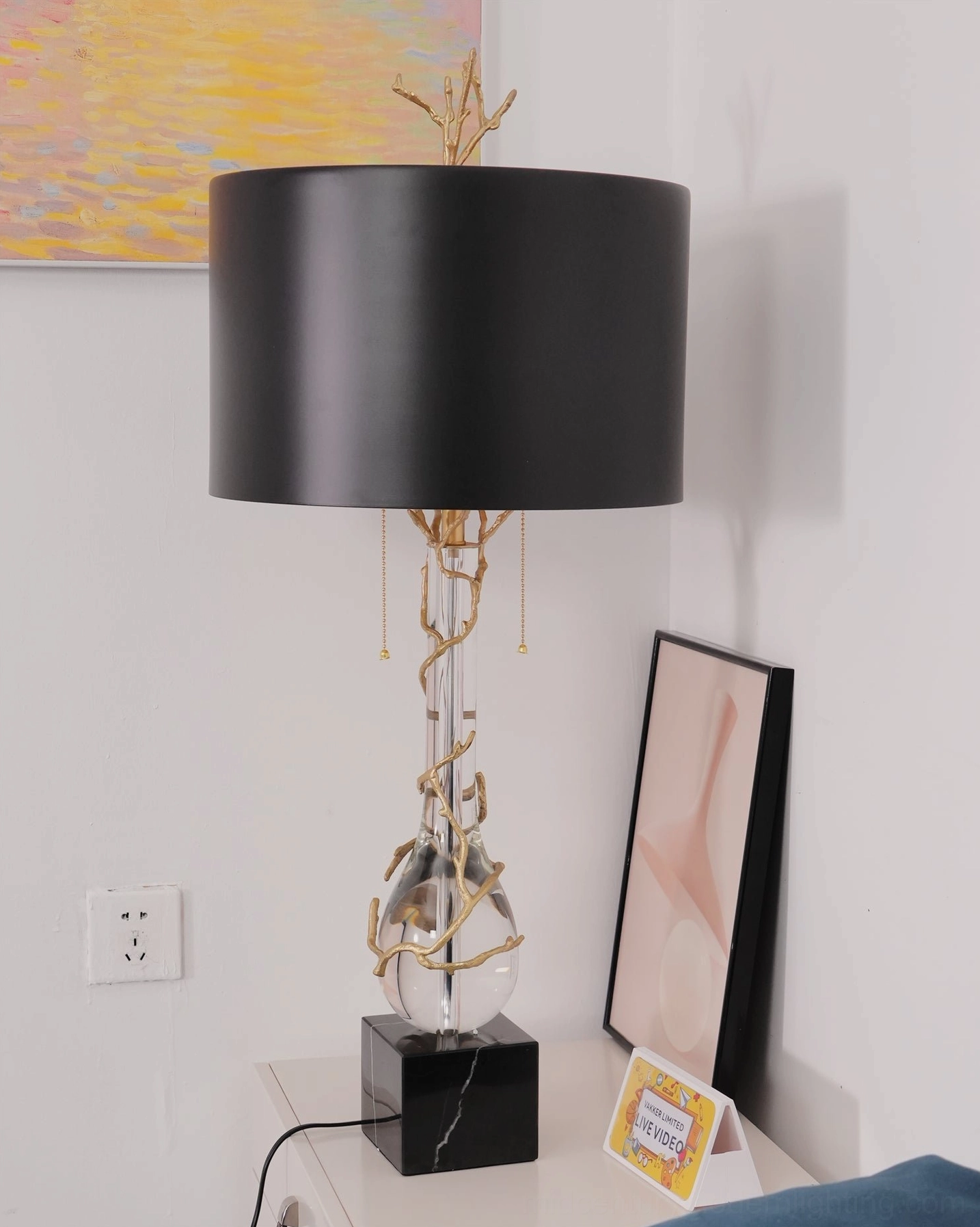 Lora modern table lamp side profile view showing black shade with gold inner lining in residential bedroom setting