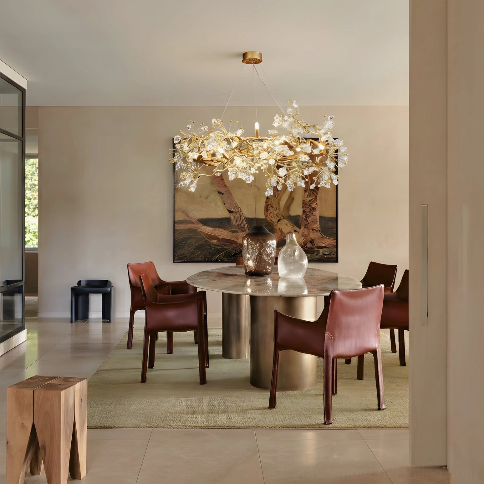 Modern brass chandelier in minimalist neutral dining room with round table