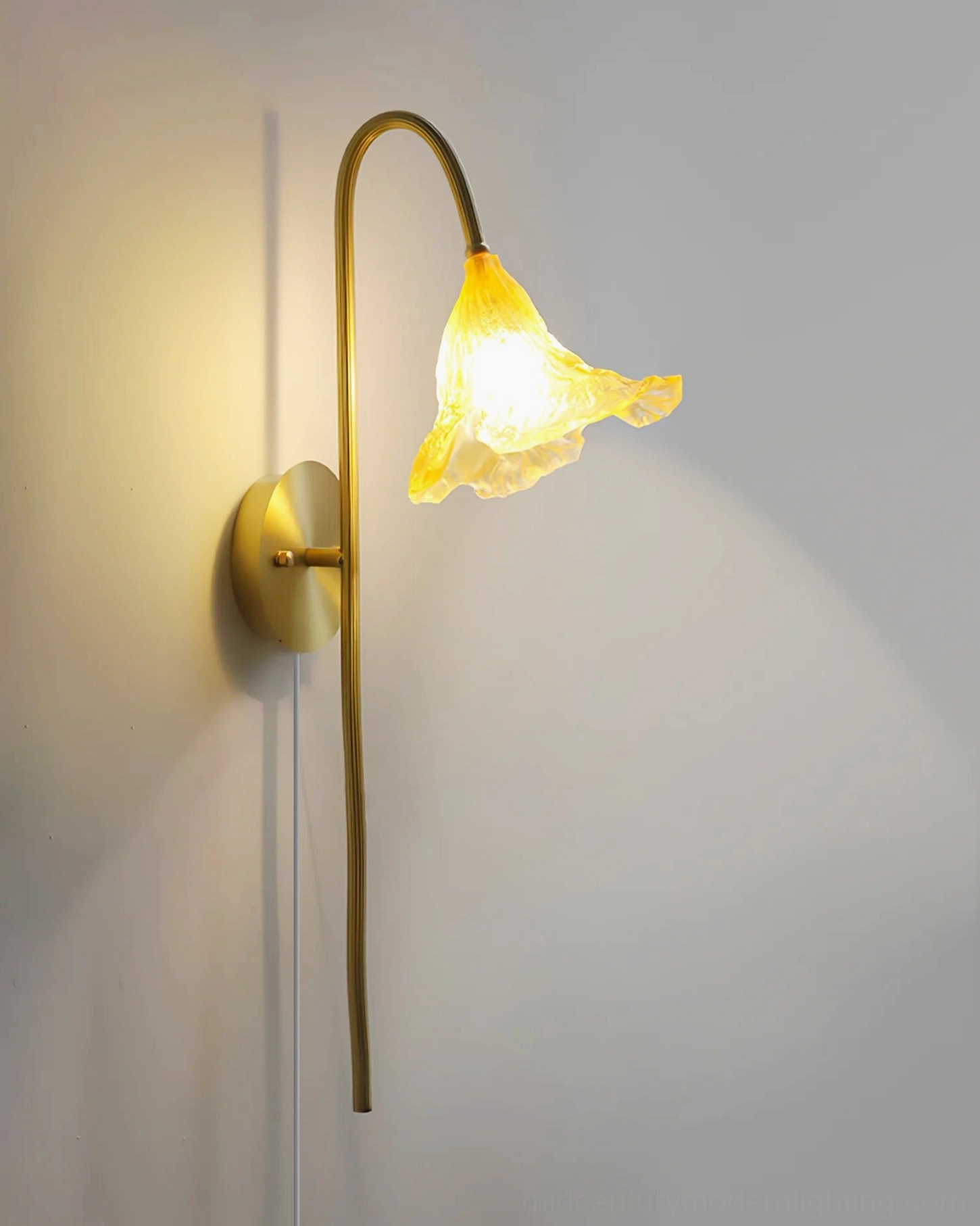 Fully illuminated lotus amber wall sconce showing distinct shadow effect on white interior wall