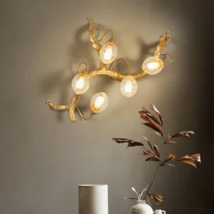 Lotus brass wall lamp installed in modern living room with green foliage decor, warm ambient lighting